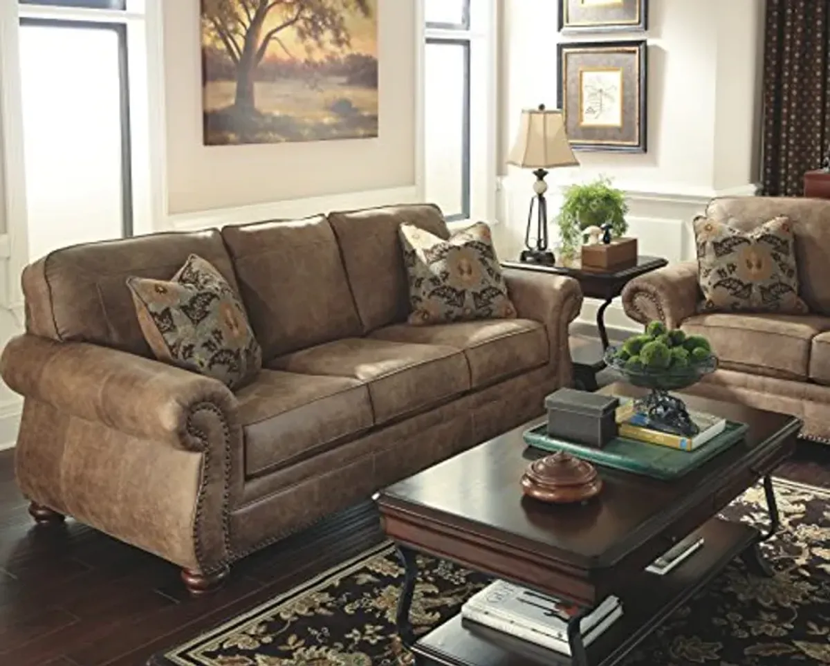 Signature Design by Ashley Larkinhurst Faux Leather Sofa with Nailhead Trim and 2 Accent Pillows, Brown