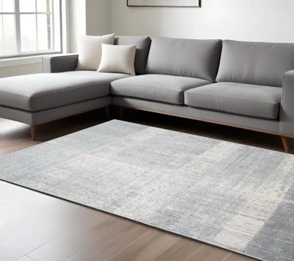 7' x 10' Abstract Stain Resistant Area Rug - White Gray And Blue