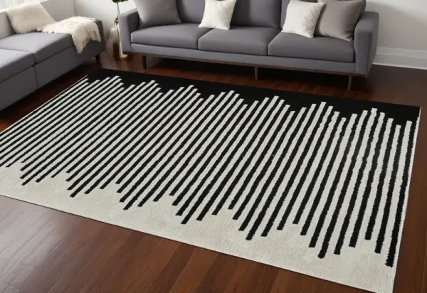 7' x 10' Abstract Distressed Polypropylene Area Rug - Cream And Black