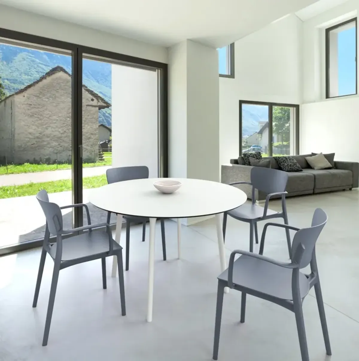 Compamia 47 Inch Lisa Round Outdoor Dining Set with White Table & Dark Gray Armchairs