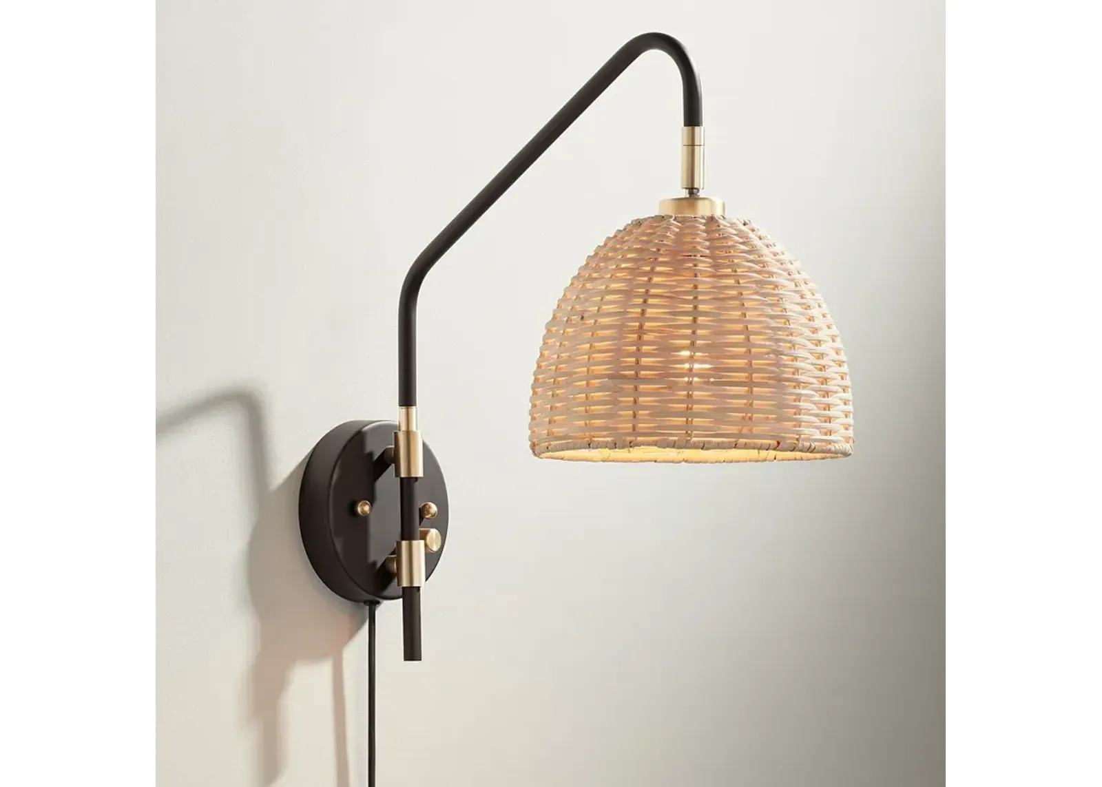 Barnes and Ivy Vega Bronze and Brass Rattan Shade Plug-In Wall Lamp