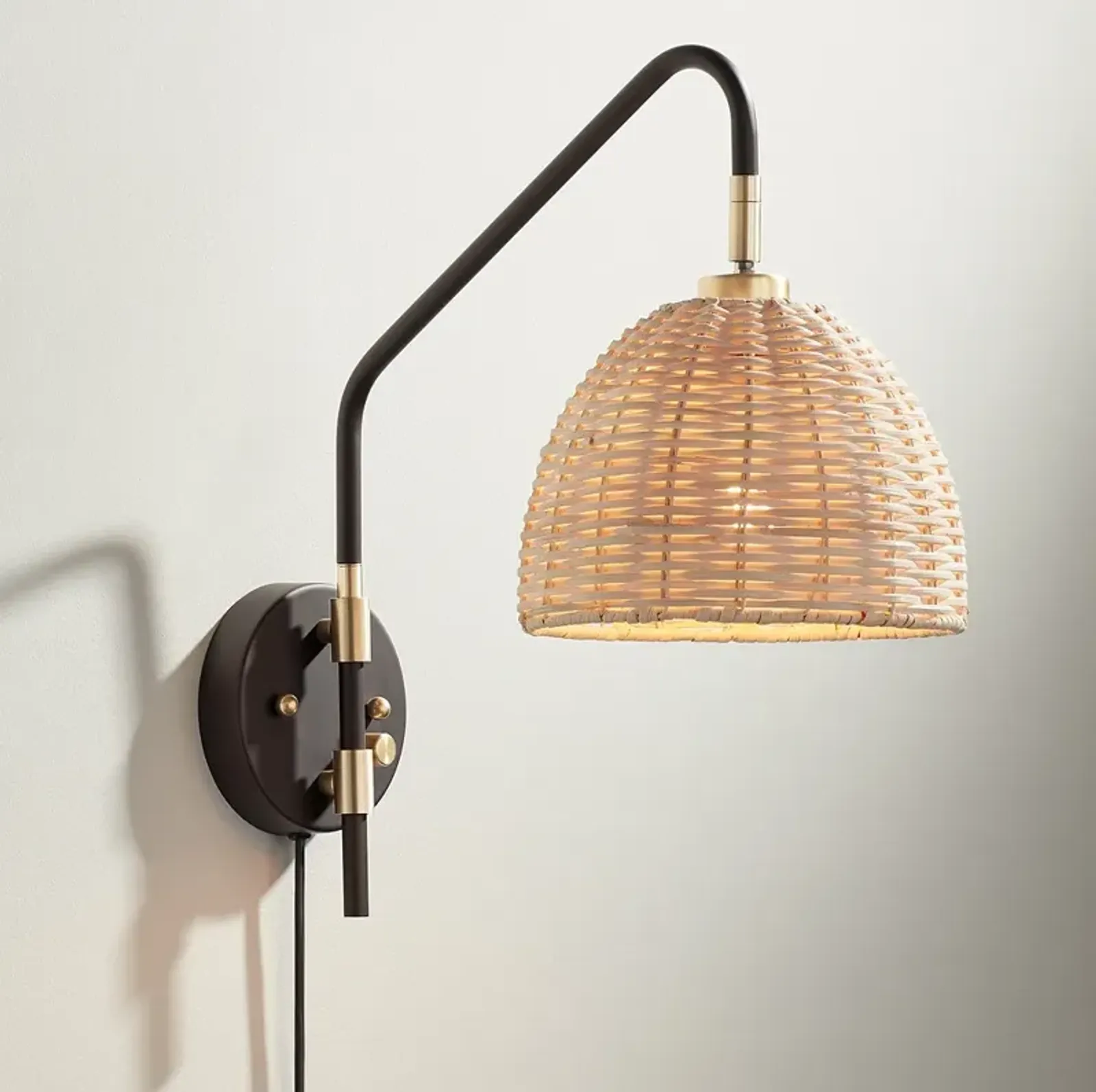 Barnes and Ivy Vega Bronze and Brass Rattan Shade Plug-In Wall Lamp