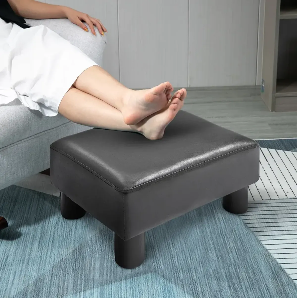 HOMCOM Ottoman Foot Rest, Small Foot Stool with Faux Leather Upholstery, Rectangular Ottoman Footrest with Padded Foam Seat and Plastic Legs, Bright Black