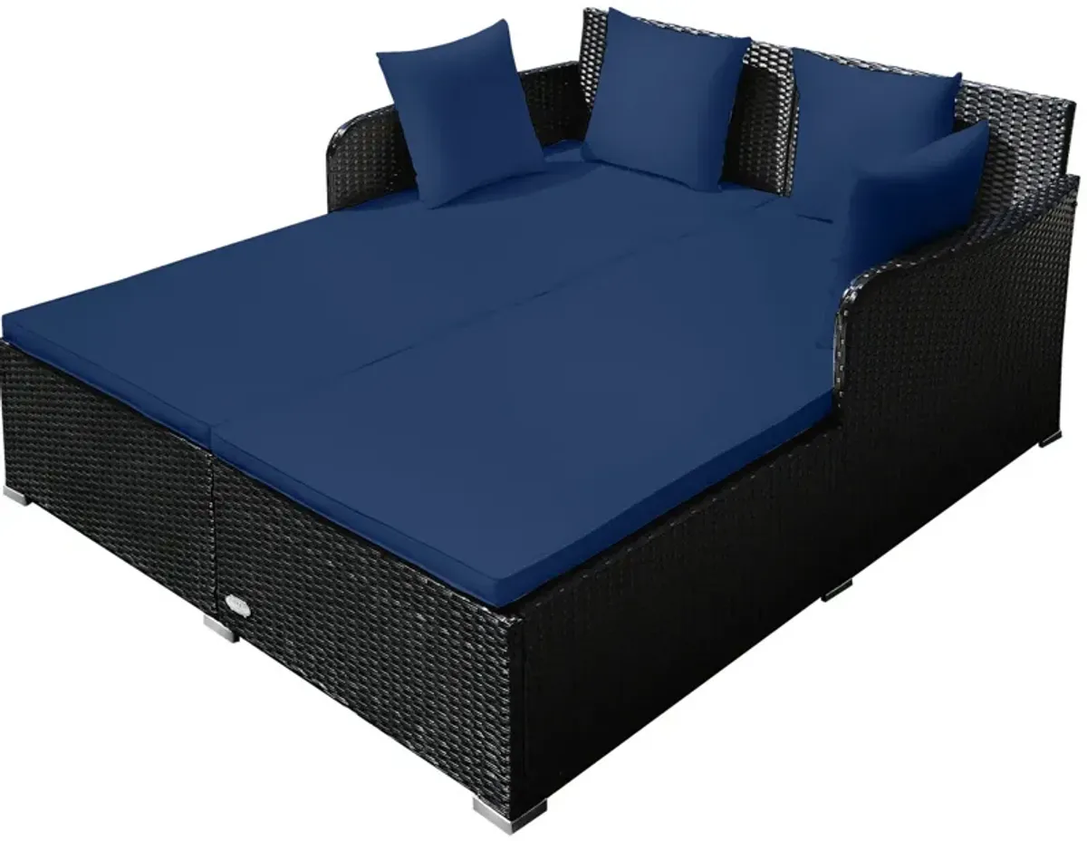 Spacious Outdoor Rattan Daybed with Upholstered Cushions and Pillows