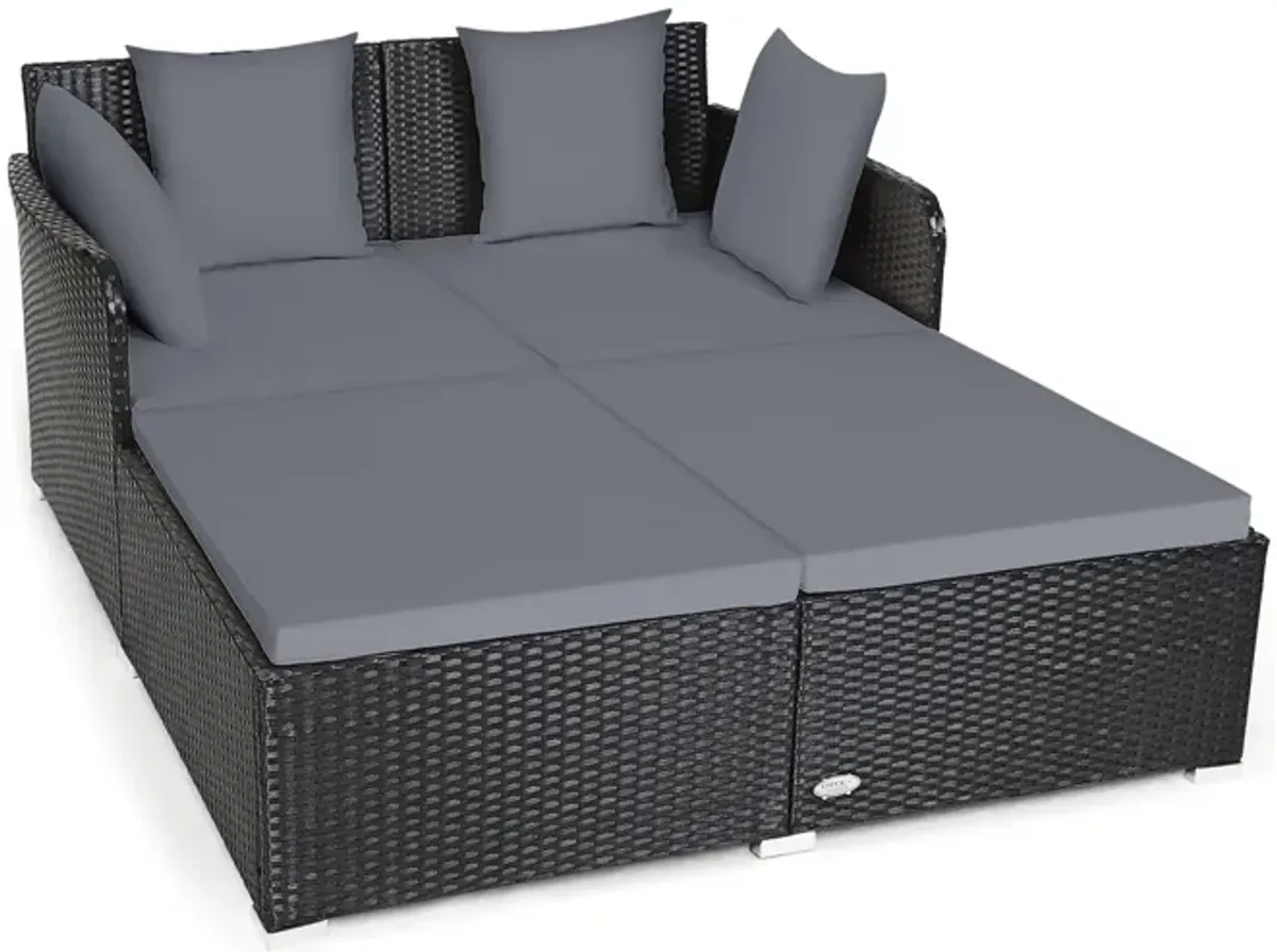 Spacious Outdoor Rattan Daybed with Upholstered Cushions and Pillows