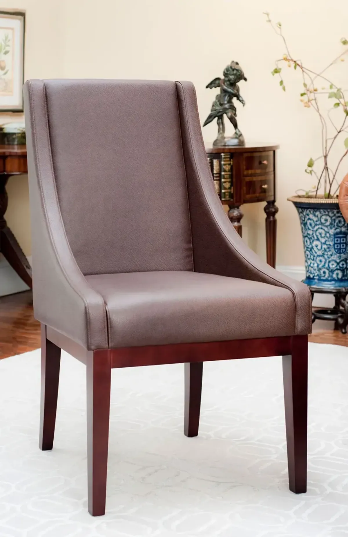 BROWN LEATHER SLOPING ARMCHAIR