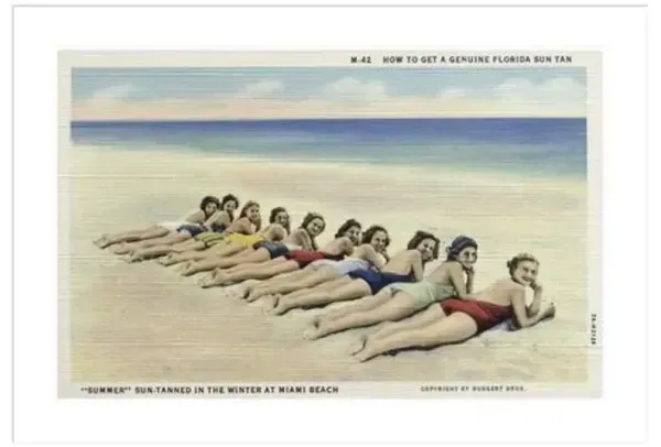 Women Sunbathing on a Beach by Burgert Brothers Framed Print - 1000Museums - White