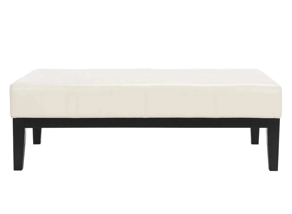 Brevin Cocktail Ottoman in Flat Cream by Safavieh