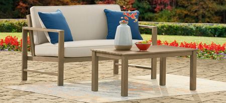 Fynnegan Outdoor Loveseat with Table in Pebble by Ashley Furniture