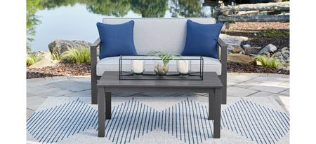 Fynnegan Outdoor Loveseat with Table in Stone by Ashley Furniture