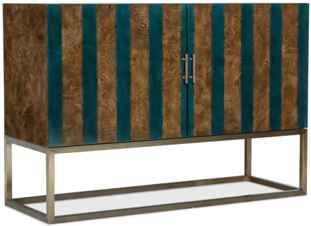 Melange Devynn Two Door Chest in Medium wood finish with blue stripes. Gold bar pull hardware and metal base. by Hooker Furniture