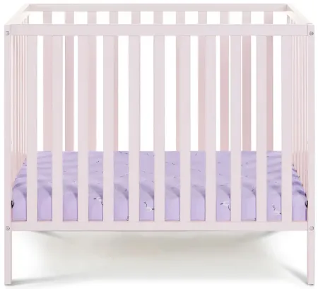 Palmer 3-in-1 Convertible Mini Crib W/ Mattress Pad in Pastel Pink by Heritage Baby