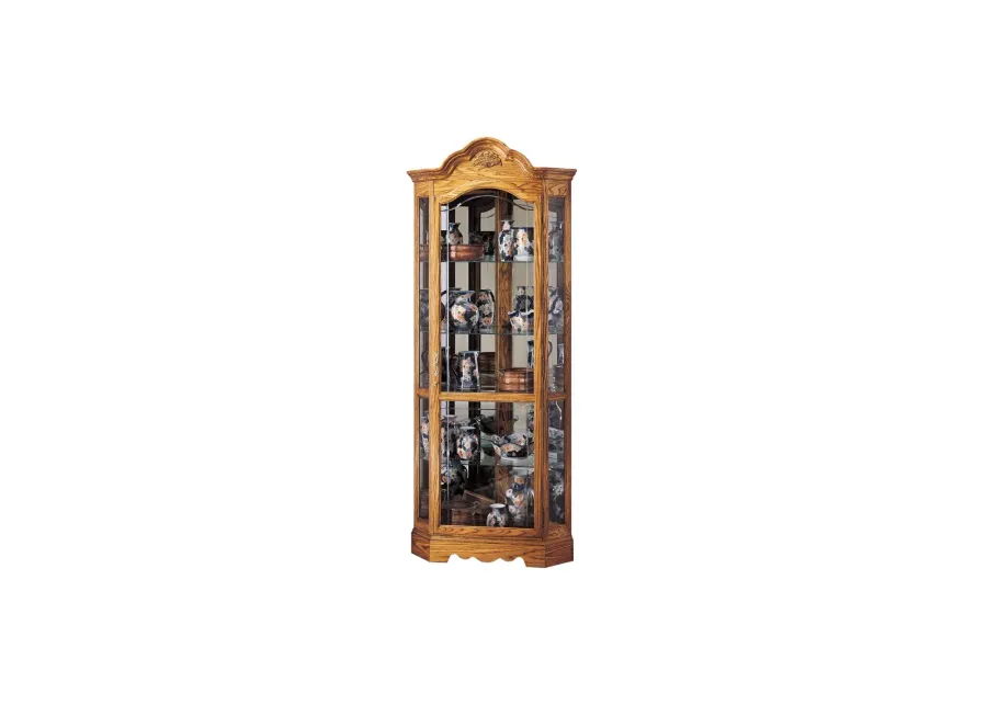 Wilshire Corner Curio Cabinet in Golden Oak by Howard Miller Clock